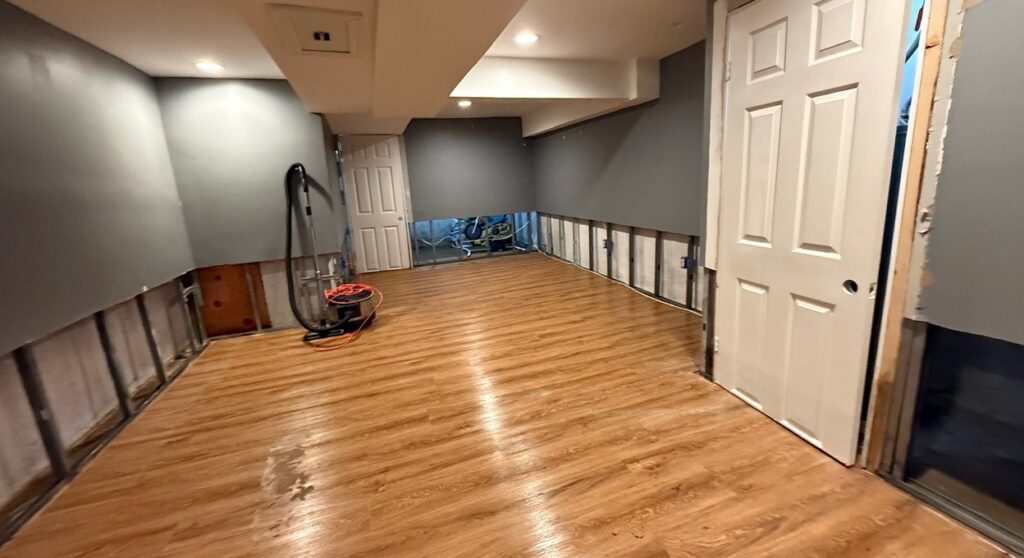 Basement with new flooring after water damage and mold restoration